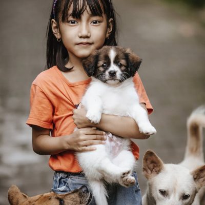 little girl holding a puppy