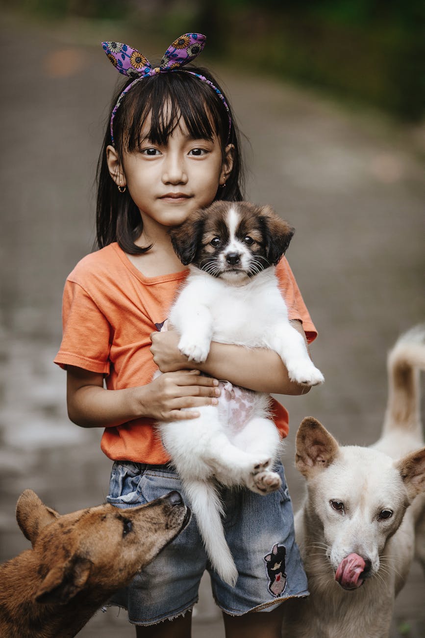 little girl holding a puppy
